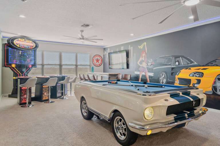 Game room with Mustang pool table, arcade, and wet bar