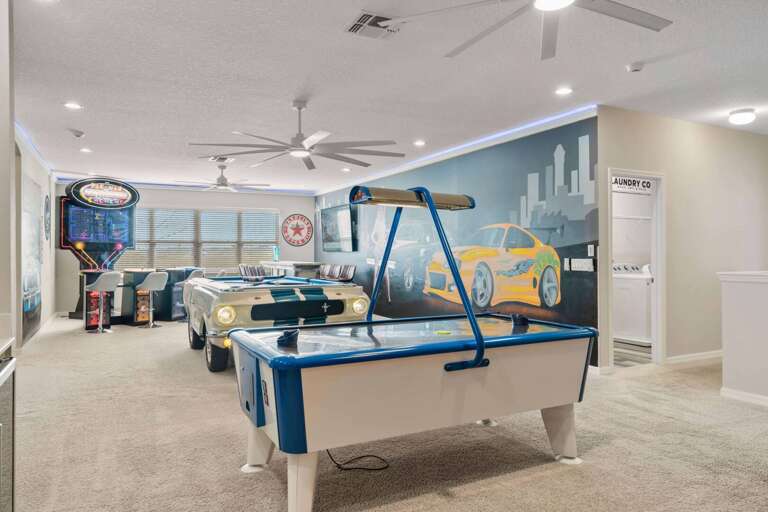 Game room with Mustang pool table, arcade, wet bar, and air hockey