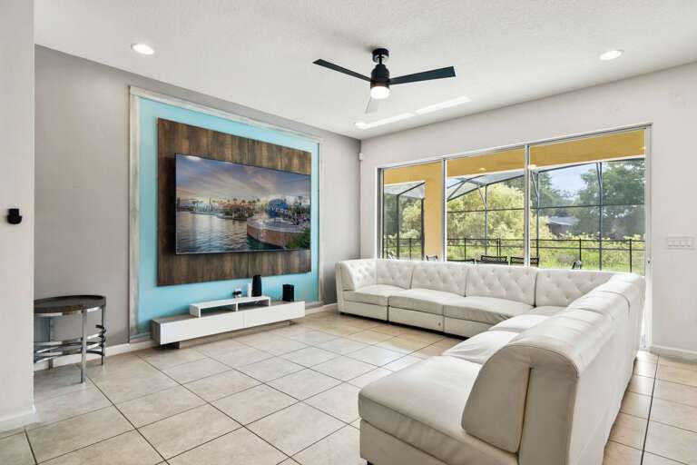 Living area with comfy sofa and 86" flat screen TV