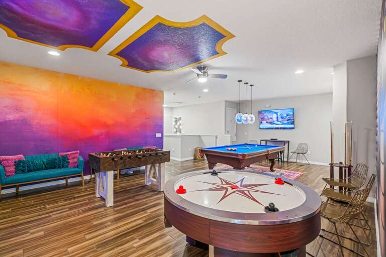 Game room with pool table, air hockey, foosball, and wet bar