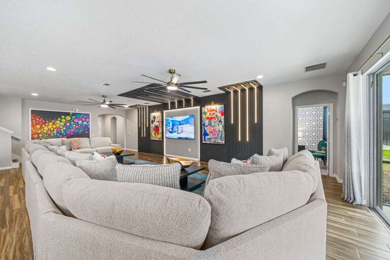 Living area with huge sectional sofa and flat-screen TV