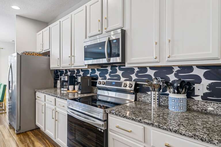 Spacious kitchen with large island and stainless-steel appliances