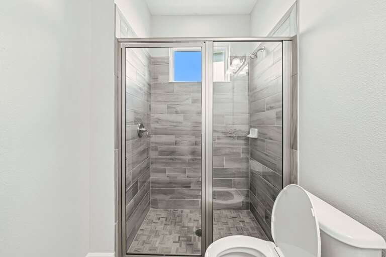 Bathroom with glass enclosed shower Bathroom with glass enclosed shower