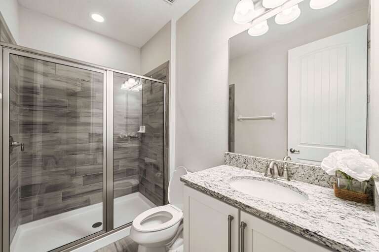 Bathroom with glass enclosed shower Bathroom with glass enclosed shower