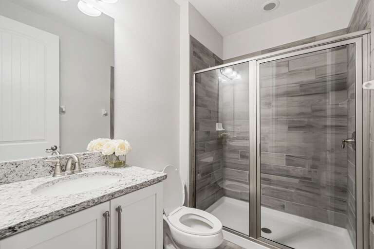 Bathroom with glass enclosed shower Bathroom with glass enclosed shower