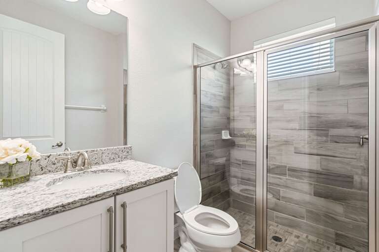 Bathroom with glass enclosed shower Bathroom with glass enclosed shower