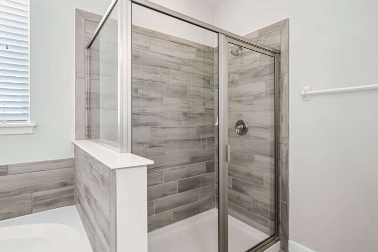 Bathroom with jetted tub, and glass enclosed shower Bathroom with jetted tub, and glass enclosed shower