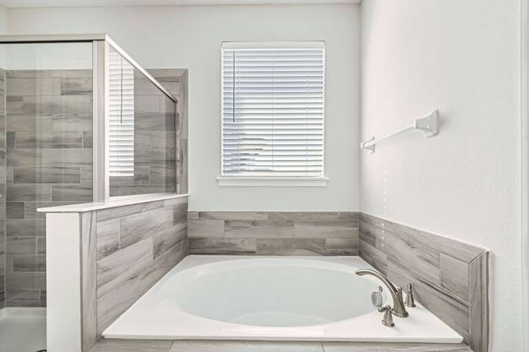 Bathroom with jetted tub, and glass enclosed shower Bathroom with jetted tub, and glass enclosed shower