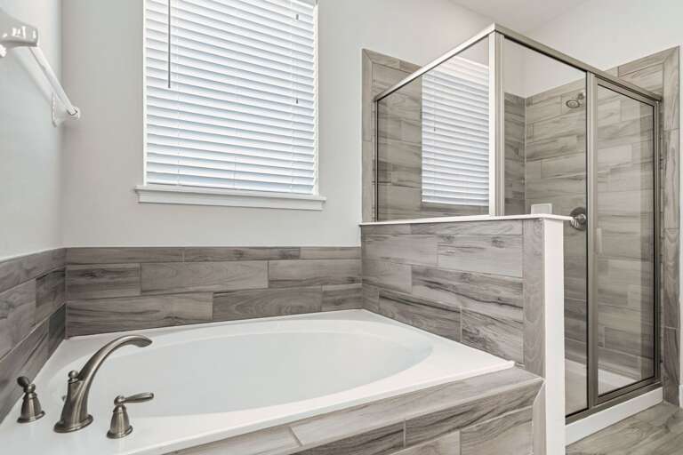 Bathroom with jetted tub, and glass enclosed shower Bathroom with jetted tub, and glass enclosed shower