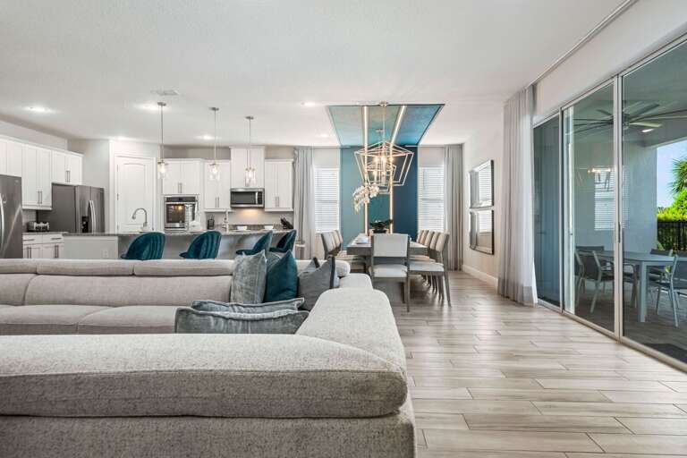 Living area and dining area leading to the patio and pool Living area and dining area leading to the patio and pool