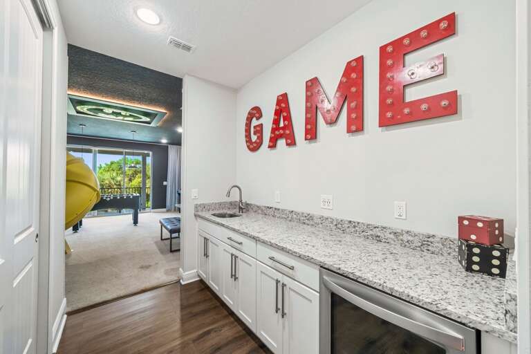Upstairs foyer leading to more bedrooms and entertainment area with sink and mini fridge Upstairs foyer leading to more bedrooms and entertainment area with sink and mini fridge