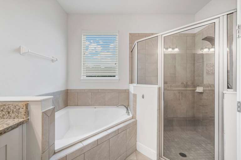 - Sleek glass showers and a plush bathtub