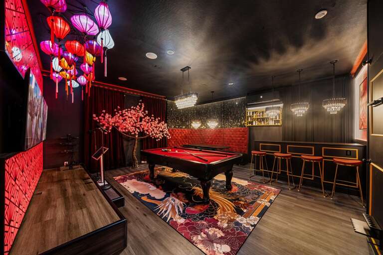 - Stylish entertainment room with cherry blossom mural
- Red-felt pool table
- Pick a mic, pick a song. one unforgettable night
- Mini bar, major vibes.