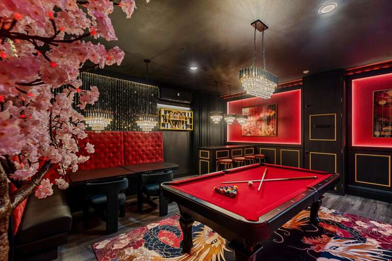 - Stylish entertainment room with cherry blossom mural
- Red-felt pool table
- Pick a mic, pick a song. one unforgettable night
- Mini bar, major vibes.