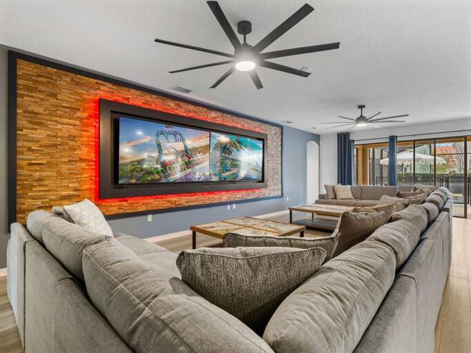 Living area with comfy couch and dual flat screen TVs
