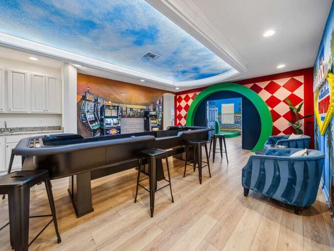 Vegas themed game room with Craps table, Blackjack Table, Slot Machines, and Wet bar
