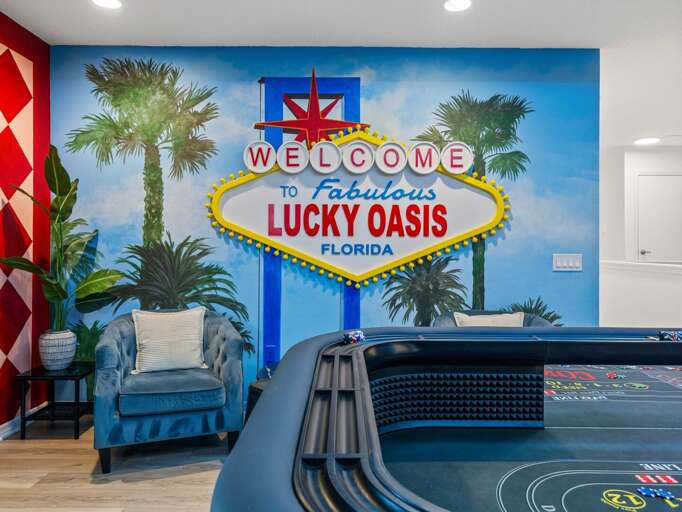 Vegas themed game room with Craps table, Blackjack Table, Slot Machines, and Wet bar