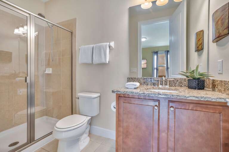 Bathroom with glass enclosed shower.
