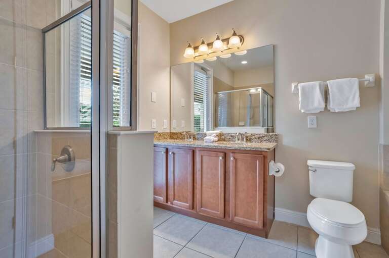 Bathroom with glass enclosed shower.