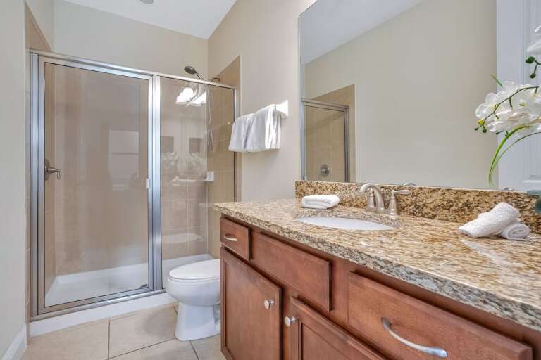 Bathroom with glass enclosed shower.