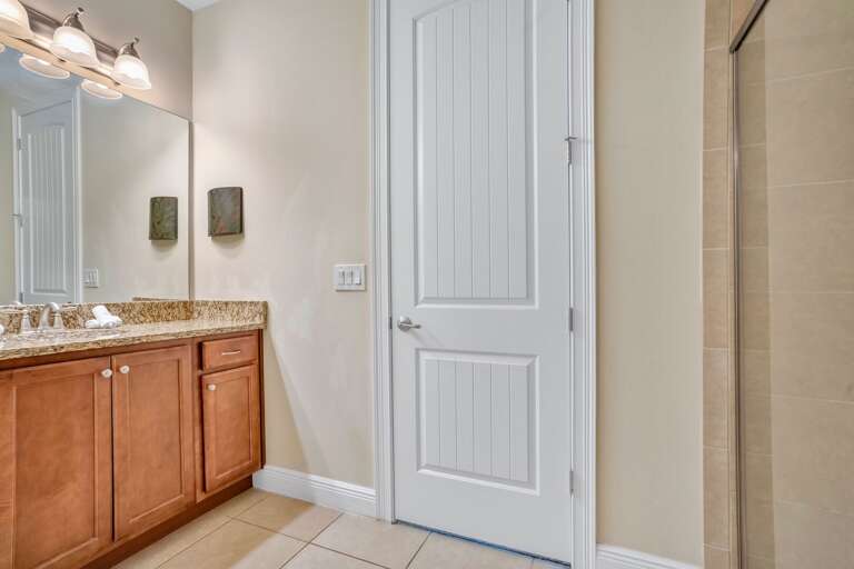 Bathroom with glass enclosed shower.