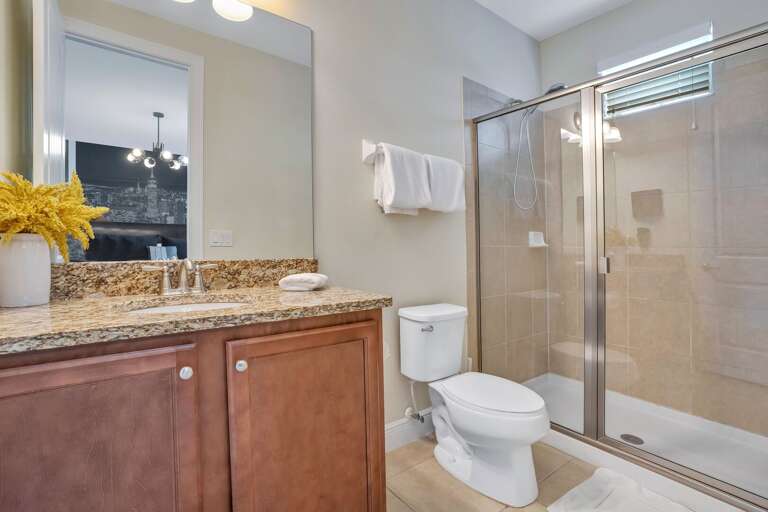 Bathroom with glass enclosed shower.