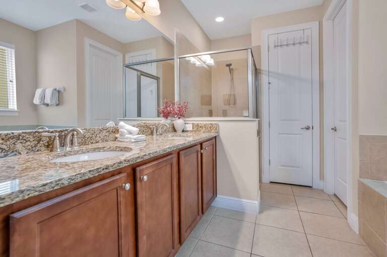 Bathroom with glass enclosed shower.