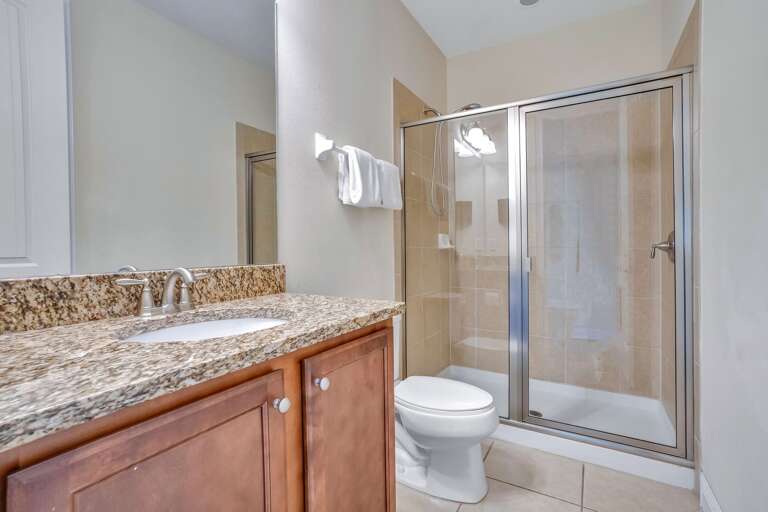 Bathroom with glass enclosed shower.