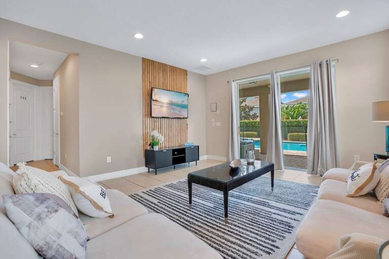 Living room with neutral tones and cozy seating.