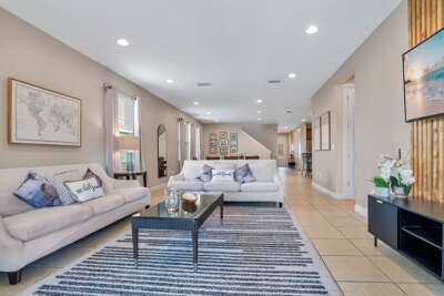 Living room with neutral tones and cozy seating.