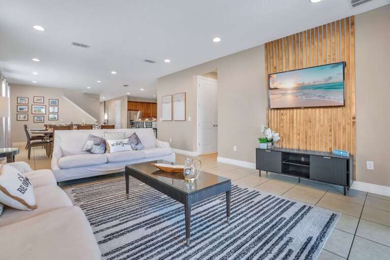Living room with neutral tones and cozy seating.