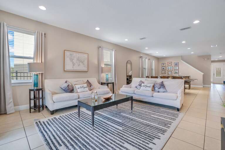 Living room with neutral tones and cozy seating.