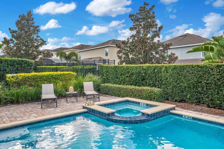 Resort-style pool with loungers.