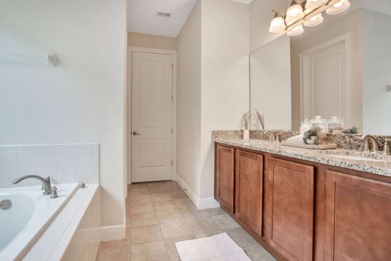 Bathroom with dual sinks and a tub