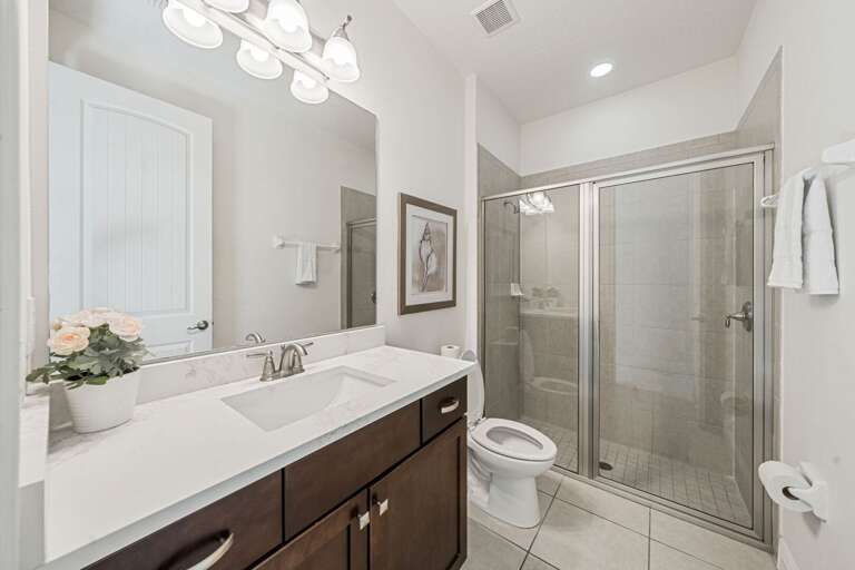 Bathroom w/ glass enclosed shower