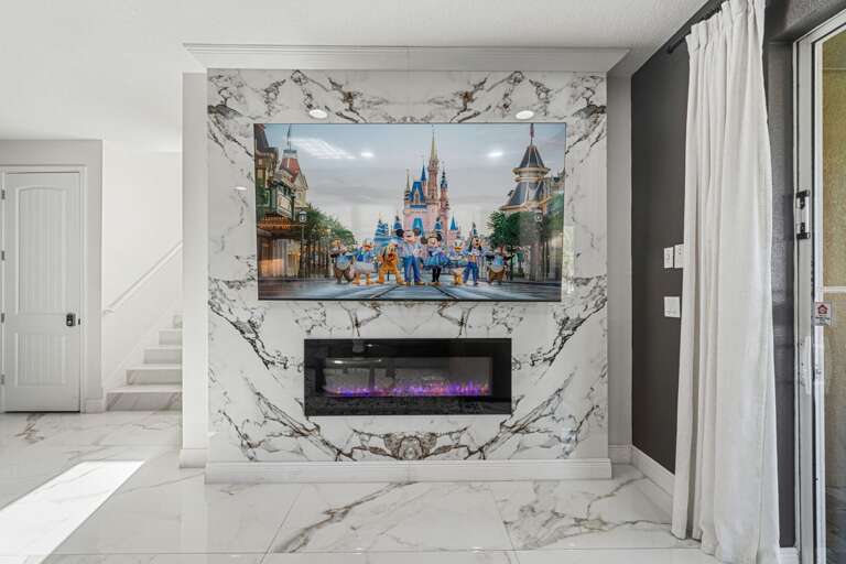 Flat-screen TV above electric fireplace