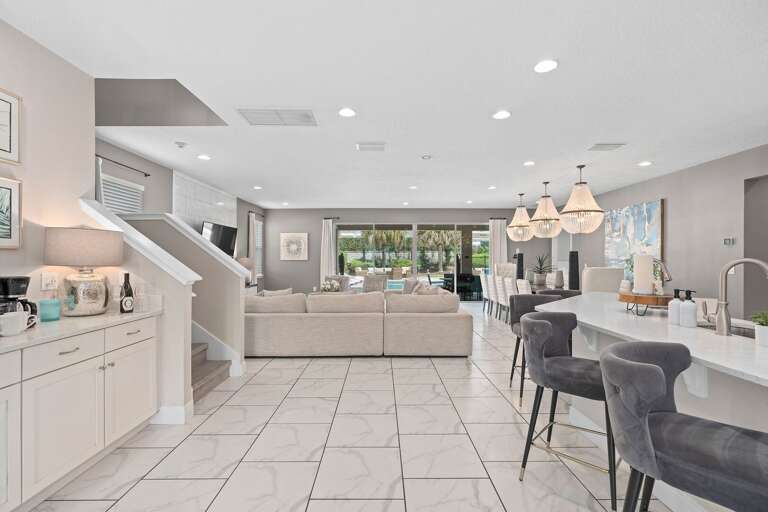 Kitchen area w/ large island and stainless-steel appliances