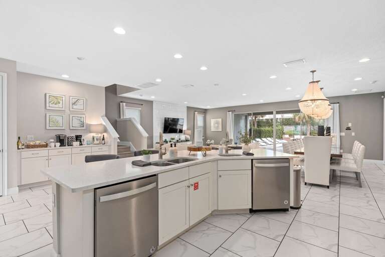 Kitchen area w/ large island and stainless-steel appliances