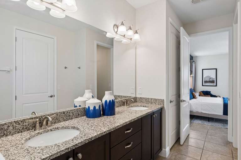 Bathroom with 2x sinks and glass enclosed shower