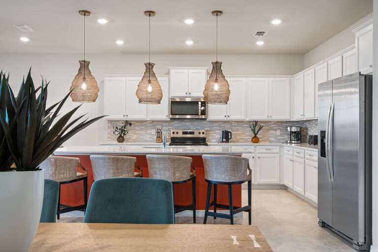 Kitchen area w/ large island and stainless-steel appliances