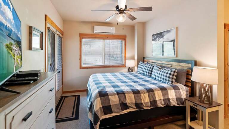 Master bedroom suite include s a king bed with AC, ceiling fan, french doors to the balcony, HDTV with streaming capabilities, closet, and an ensuite bathroom.