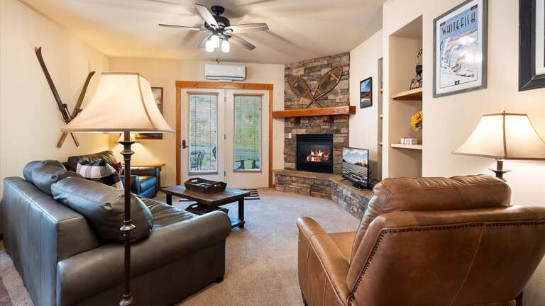 Open concept living room with a full size sofa sleeper, HDTV with streaming capabilities, and a gas fireplace to enjoy after a long day on the slopes.