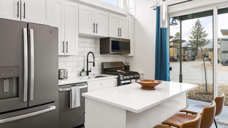 Fully stocked kitchen with breakfast bar seating for 3.