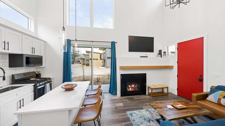 Main living space with open concept living room and kitchen. The living room features a luxury queen sofa sleeper.