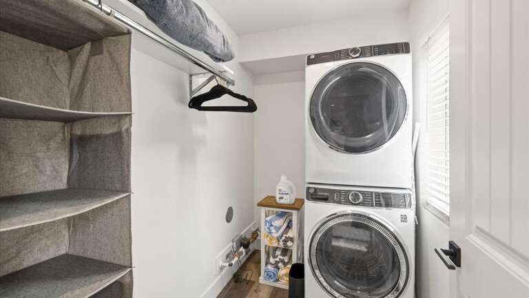 The master bedroom walk-in closet with washer and dryer.