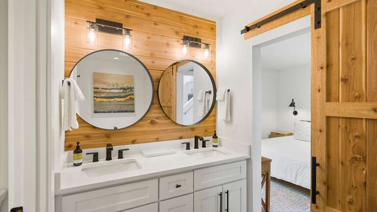 The master ensuite bathroom with double vanity, giant soaker tub, private toilet, and walk-in shower.