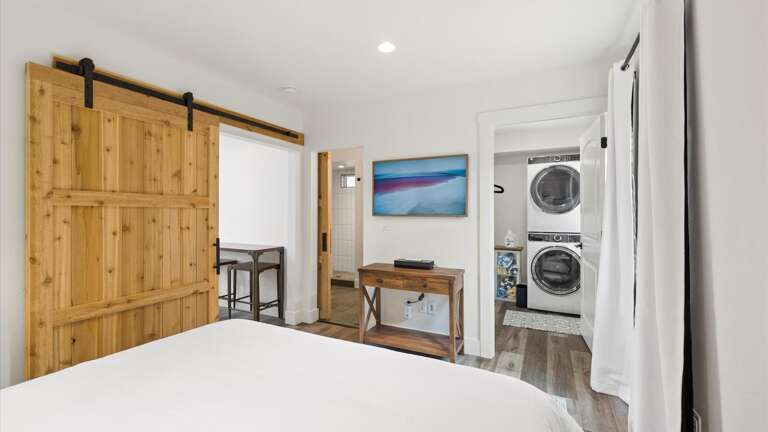 The master suite includes a luxury king mattress with top of the line linens, walk-in closet with laundry, ensuite bathroom, and HD Frame TV with streaming capabilities.