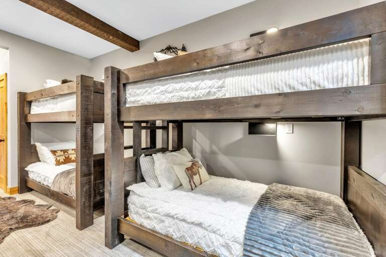 Each bunk includes a charging station and beside lamp.