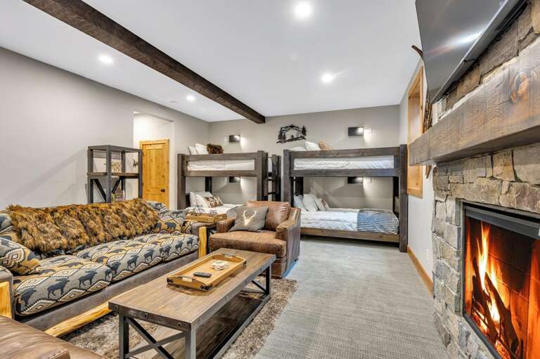 Head back down to the lower level kids suite which features four twin bunks with luxury linens and mattresses, a queen sofa sleeper, gas fireplace, and HDTV with streaming capabilities and cable, ensuite bathroom, and large walk-in closet.