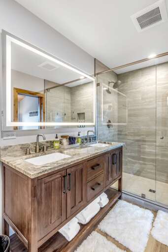 Master ensuite bathroom with luxury walk-in shower, high end electric mirrors, double vanity, toilet and walk-in closet.